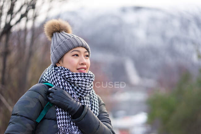 Азійська жінка - туристка в теплому одязі на сніговій природі. — стокове фото