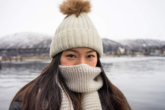 Asian female in warm wear at snowy mountain area — Stock Photo