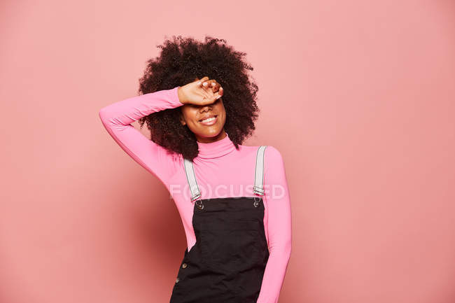 Young African American woman covering eyes with hand — Stock Photo
