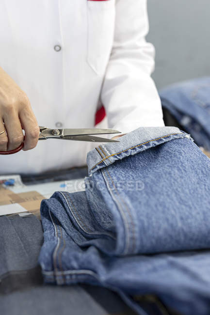 Worker in textile factory checking the quality of the garments. Industrial production — Stock Photo