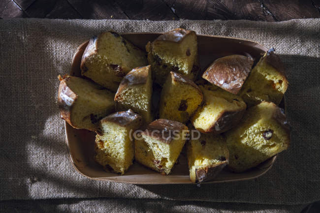Tray with pieces of homemade panettones on rustic napkin — Stock Photo