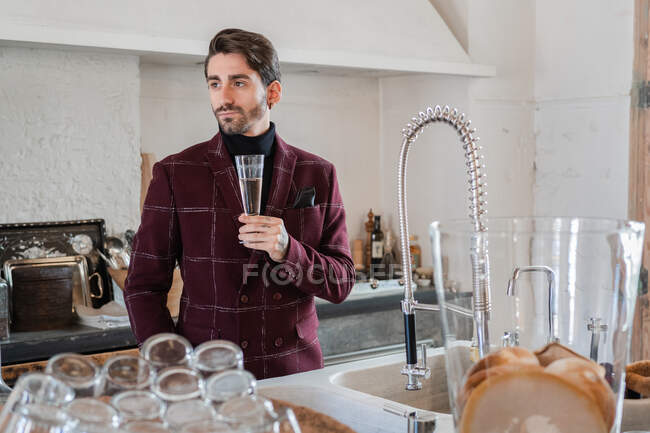 Serious adult businessman celebrating success alone at home — Stock Photo