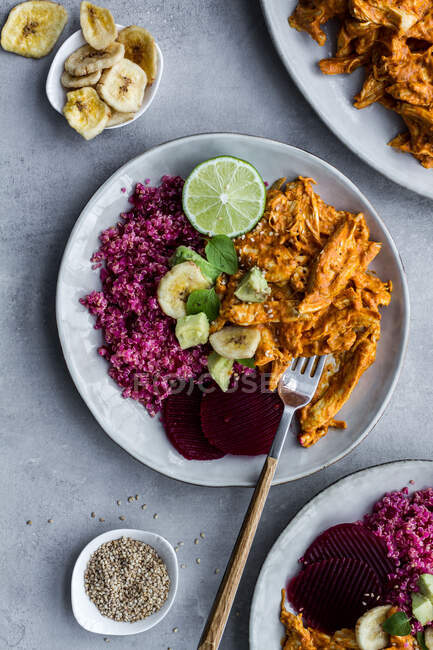 Plates with red quinoa and chicken curry — Stock Photo
