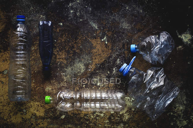 Ansicht von Plastikflaschen und -boxen auf schäbig verschmutztem Boden — Stockfoto