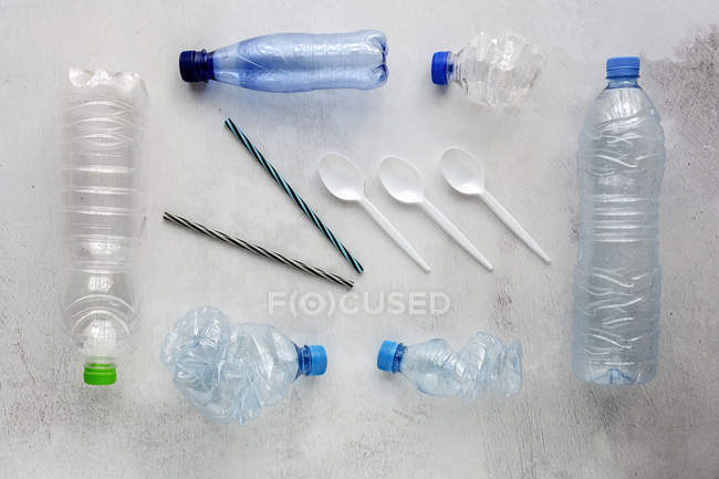Top view of plastic bottles and boxes arranged on white background surface — Stock Photo