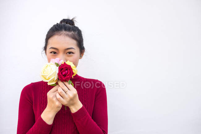Asiática mujer mostrando rosa ramo en cámara - foto de stock