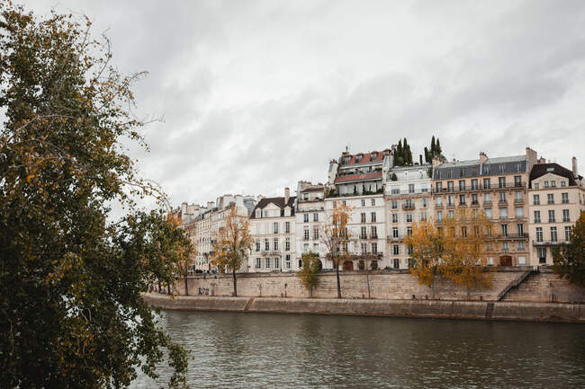 View of aged buildings and river from waterfront of France in fall — Stock Photo