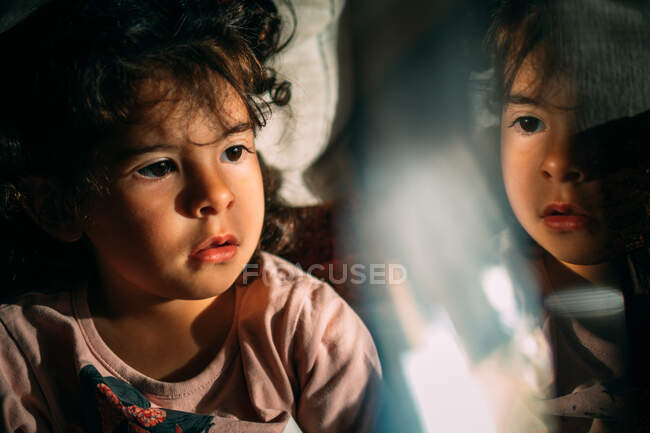 Little child reflecting in glass at night — Stock Photo