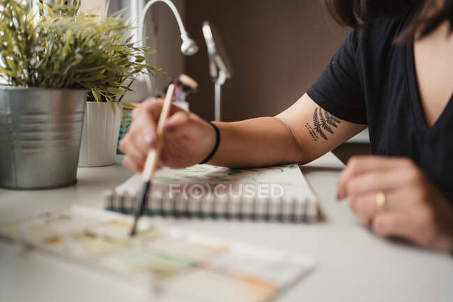 Artista feminina sem rosto pintura com aquarelas em casa — Fotografia de Stock