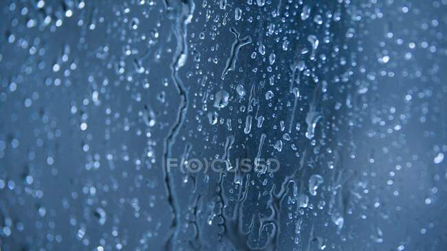 Drops of water on blue background — Stock Photo
