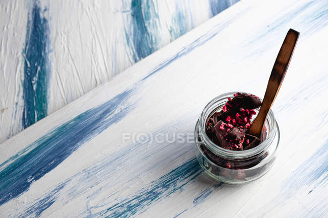 Delicious chocolate in glass jar on table — Stock Photo