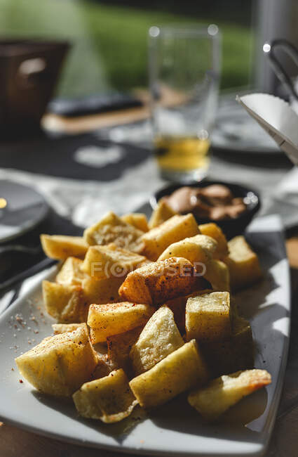 Dish of baked potatoes in restaurant — Stock Photo