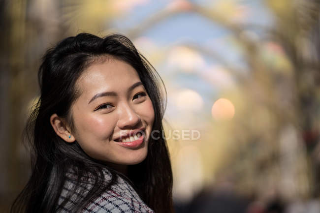 Happy young woman on street in downtown — Stock Photo