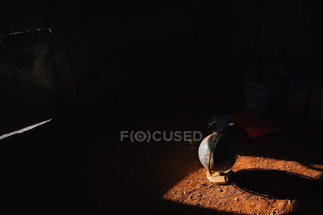 Globe model with map of Earth on ground in dark garage in Venice beach — Stock Photo