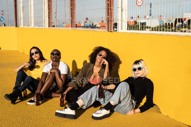 Serious youthful multiracial female friends resting on stadium — Stock Photo