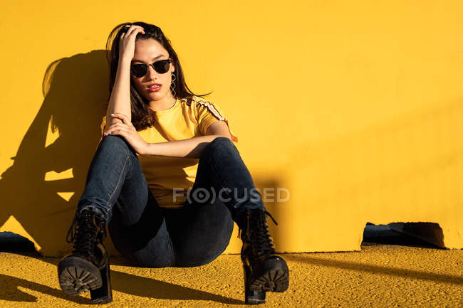 Calm young woman enjoying sunlight on stadium — Stock Photo