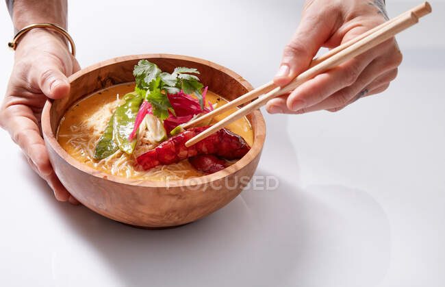 Anonymous woman with chopstick and Asian dish — Stock Photo