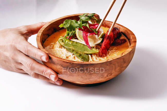 Anonymous woman with chopstick and Asian dish — Stock Photo