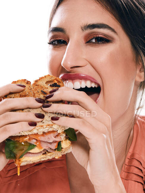 Woman with tasty double sandwich in hands — Stock Photo