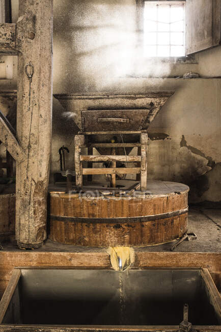 Meccanismo di macinazione Shabby situato all'interno di un antico mulino nella giornata di sole in campagna — Foto stock