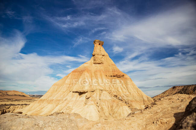 Big brown cliff with colorful blue sky and white clouds on background at Bardenas Reales at Spain — Stock Photo