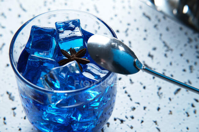 Blue cocktail with ice in glass — Stock Photo