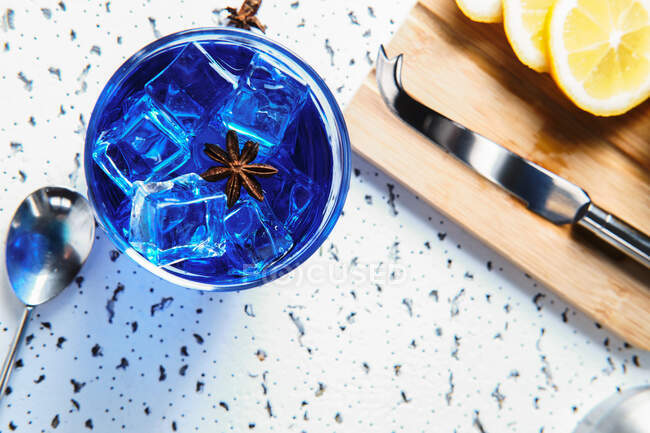 Blue cocktail with ice in glass — Stock Photo