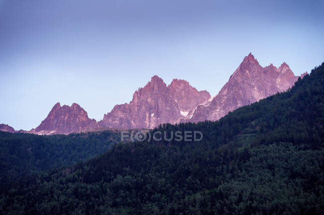 White sharp mountain peaks in snow raising up to cloudy sky — Stock Photo