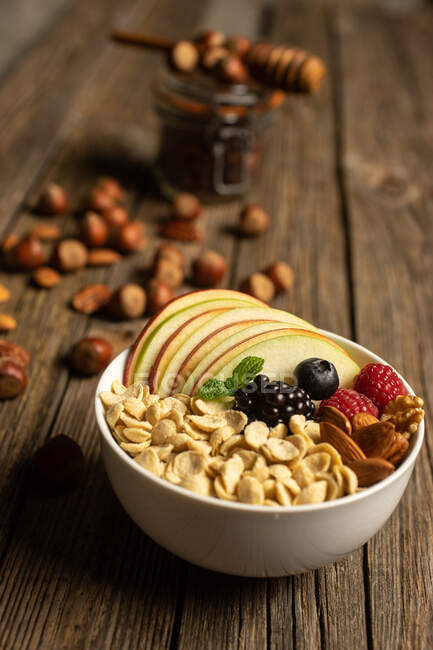 Bowl with nuts fruit and berries — Stock Photo
