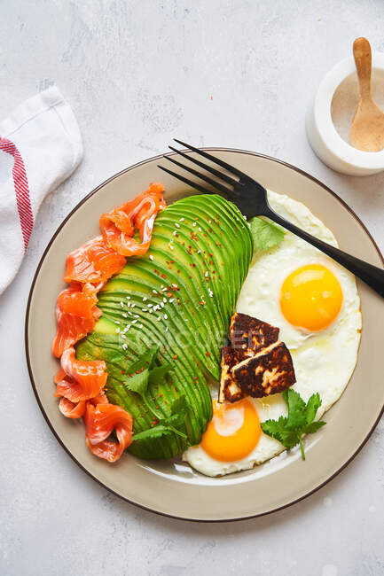 Desayuno saludable con huevos fritos y aguacate - foto de stock
