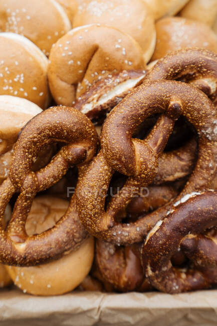 Display with baked grain sticks and buns various pastry in market stall — Stock Photo