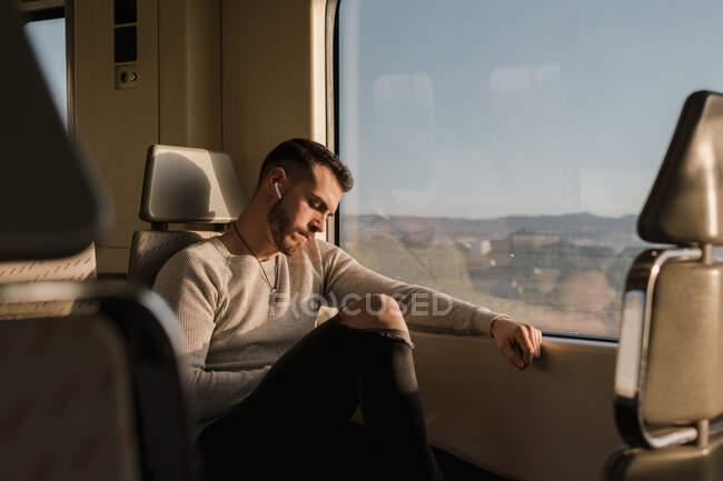 Young male passenger using smartphone in subway — Stock Photo