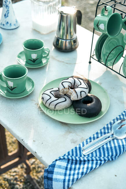Пикник с вкусным десертом и ароматным кофе в саду — стоковое фото