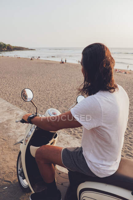 Cheerful biker on sandy beach — Stock Photo