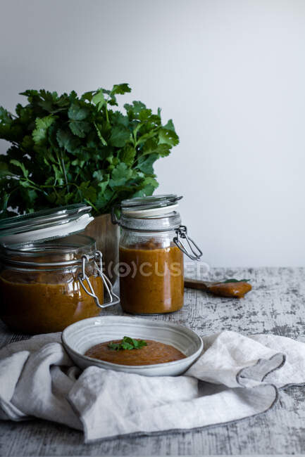 From above homemade tasty spicy chutney mango in glass jars and bowl on table — Stock Photo