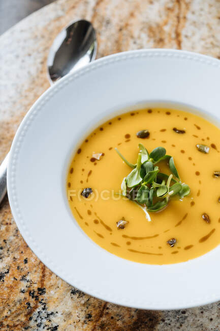 From above tasty appetizing vegetable cream soup in white plate at table in cafe — Stock Photo