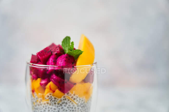 Delicious fruit dessert in glass — Stock Photo