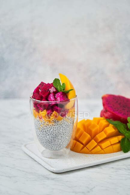 Delicious fruit dessert in glass — Stock Photo