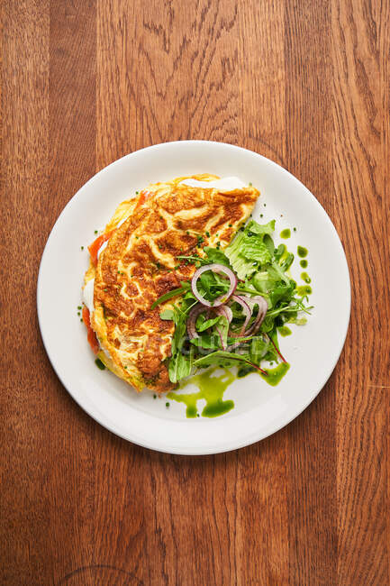 Tasty fried tortilla with salad — Stock Photo