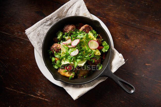 Roasted meatballs and salad in pan — Stock Photo