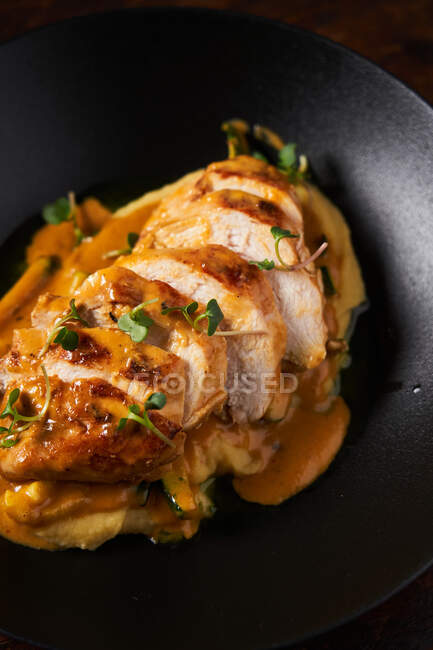 Modern dish with baked chicken and sauce — Stock Photo
