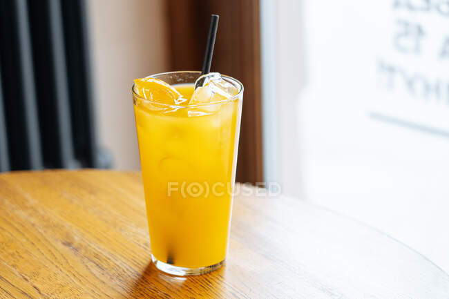 Tasty cold orange cocktail on table — Stock Photo
