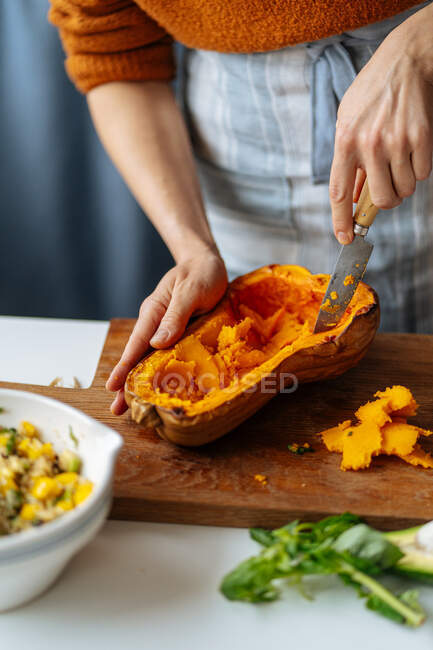 Woman preparing pumpkin for filling — Stock Photo