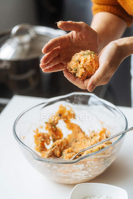Crop hands of housewife preparing healthy meatless cutlets with homemade stuffing made from salmon and potato — Stock Photo