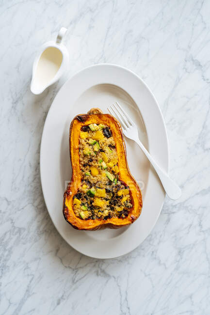 Stuffed squash with quinoa and vegetables on white plate — Stock Photo