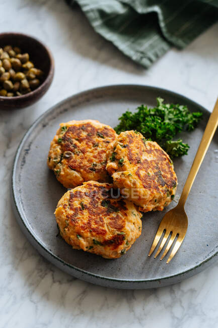 Grilled fish cutlets on metal plate — Stock Photo