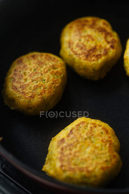 From above tasty vegetable cutlets with golden brown preparing in pan on stove in kitchen — Stock Photo