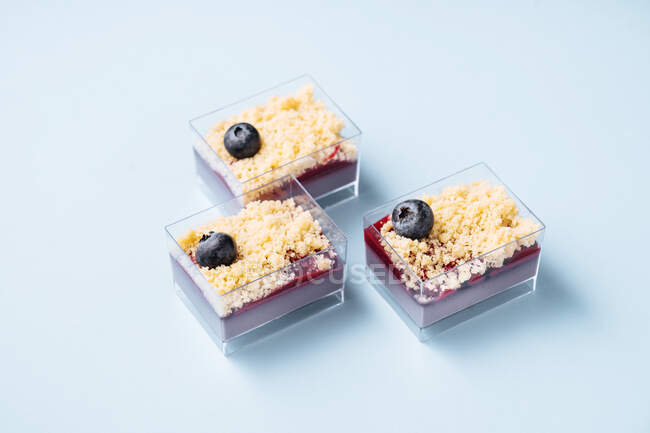 Glass containers with blueberry cakes — Stock Photo