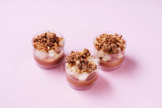 From above glass cups with delectable chocolate mousse placed on pink background — Stock Photo