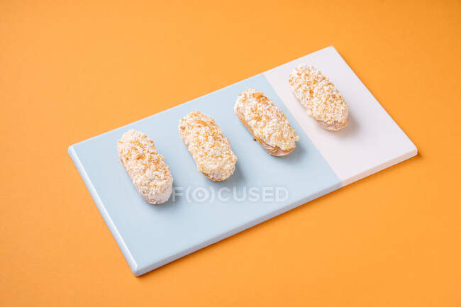 Sweet eclairs with white frosting — Stock Photo